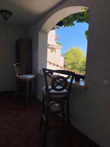 a chair sitting in a room with a window at La Terraza del Oasis in Lozenets