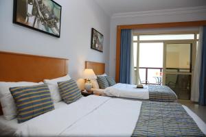Voodi või voodid majutusasutuse Atana Khasab Hotel toas