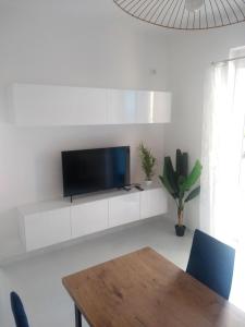 a living room with a tv on a white wall at Beautiful Sarandë in Sarandë