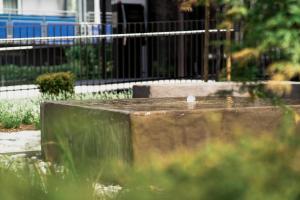 a bird sitting on top of a fountain in a park at LOOMZ living Self-check-in in Innsbruck