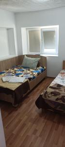 a bedroom with a bed and two windows at Casa Vio in Eforie Nord