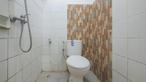 a bathroom with a toilet and a shower at RedDoorz At Pujon Malang in Batu +44 photos