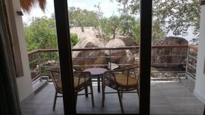 a room with a table and chairs on a balcony at Oruwa Boutique Villas in Arugam Bay