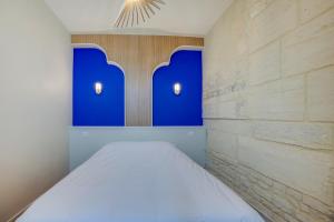 Posteľ alebo postele v izbe v ubytovaní Villa Les Hirondelles - Appartement avec Jardin Front de mer