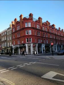a large red brick building on a city street at Stunning 1 Bedroom in Stunning Location - Mayfair Area in London
