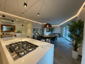 a kitchen and living room with a stove top oven at Villa Elvira in Gardone Riviera