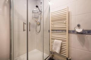 a shower with a glass door in a bathroom at Swinside Lodge in Keswick +96 photos