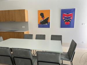 Una sala de conferencias con una mesa y sillas blancas. en Venus and Aprilia - Luxury by the Coast, en Petrčane