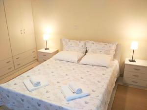 a bedroom with a bed with two towels on it at Apartment Villa Panorama in Thessaloniki