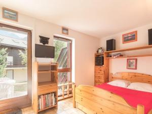 a bedroom with a bed and a large window at Appartement Saint-Chaffrey , 1 pièce, 4 personnes - FR-1-330E-44 in Saint-Chaffrey