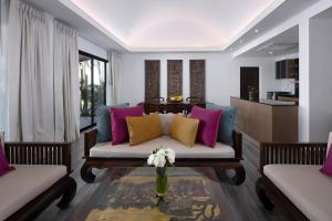a living room filled with furniture and a couch at Celes Beachfront Resort Koh Samui - SHA Extra Plus in Bophut