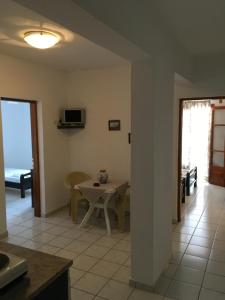 a kitchen and dining room with a table and a television at Villa Fantasia in Skiathos