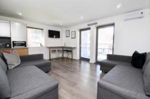 a living room with two couches and a table at Campbell Square Apartment 3 in Liverpool