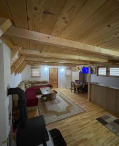 a living room with a couch and a table at Vikendica Bosnjak in Sarajevo