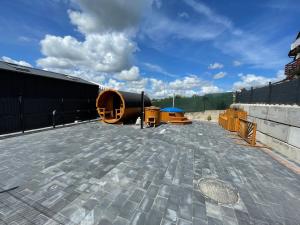 a patio with a building and a blue sky at Zatoka Marina in Mechelinki +6 photos