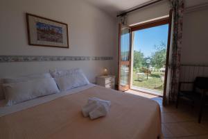 Posteľ alebo postele v izbe v ubytovaní Poggio delle Rose Tuscany Relais