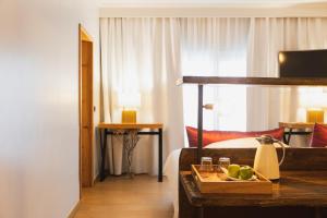 a hotel room with a bed and a tray of fruit on a table at Quinta da Abelheira in Ponta Delgada