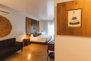 a bedroom with a bed and a couch in a room at Quinta da Abelheira in Ponta Delgada +63 photos