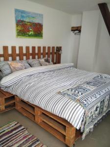 a large bed with a wooden frame in a room at Agrocamp in Pawłówka