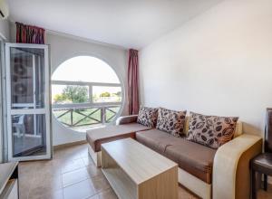 a living room with a couch and a table at Saint George Hotel 1 in Balchik