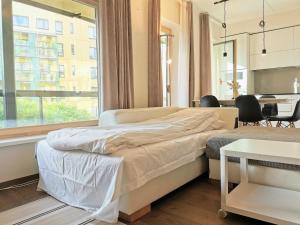 um quarto com uma cama, uma mesa e uma janela em Scandian Apartments - City Centre Tallinn em Talin
