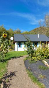 a white house with a black roof at Osada Leonówka Bieszczady in Cisna