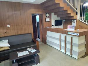 a living room with a couch and a staircase at Meghdoot river resort in Cochin