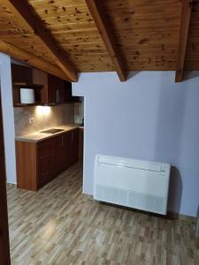 a kitchen with a white dishwasher in a room at Lovely 1 - bedroom loft with free parking in Gjirokastër