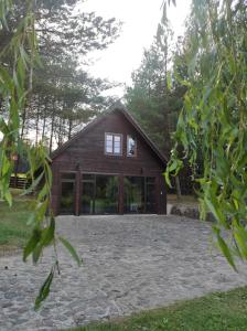 a house with glass doors and a large yard at Dom Wakacyjny Krawno in Piecki +5 photos