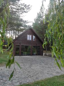 a house with glass doors and a large yard at Dom Wakacyjny Krawno in Piecki
