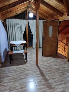 a room with a table and a bench on a tile floor at Lovely 1 - bedroom loft with free parking in Gjirokastër