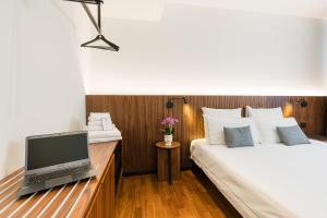 a bedroom with a desk with a laptop on a bed at Hotel Casa Scaligeri in Sirmione