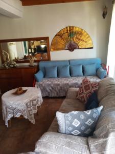 a living room with a couch and a table at Irene's loft in Ágios Matthaíos
