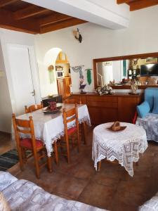 a living room with two tables and a kitchen at Irene's loft in Ágios Matthaíos