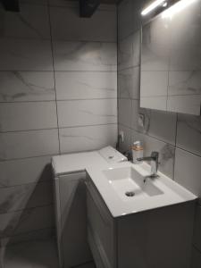 a bathroom with a sink and a mirror at Gîte du Mont in Saint-Hippolyte