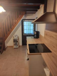 a kitchen with a stove and a counter top at Gîte du Mont in Saint-Hippolyte +8 photos