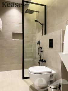 a bathroom with a toilet and a shower in it at Kease Malqa B-11 Royal touch AZ60 in Riyadh