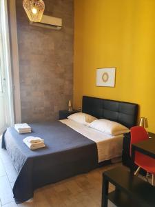 ナポリにあるEmyJo Central B&Bのベッドルーム1室(ベッド1台、タオル2枚付)