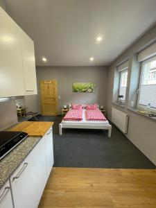 a kitchen with a bed in the middle of a room at Pension Ratsgasse in Weißensee