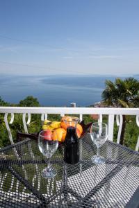 a table with three wine glasses on a balcony at Bela Vista 5 Rustikales Appartement in Volosko