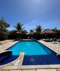 una piscina de agua azul en un complejo en Pousada Encanto dos Anjos, en Pirenópolis
