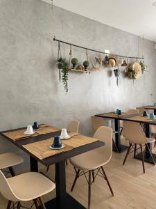 a dining room with wooden tables and chairs at Marsuites in Armação de Pêra