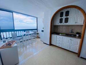 a kitchen with a view of the ocean from a balcony at Beach Apartment 9 in Patalavaca