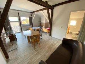 a living room with a table and a dining room at Apartmenthaus Wesseln in Wesseln
