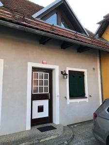a house with a green door and a car at Spa House Lotus in Terme Čatež in Čatež ob Savi