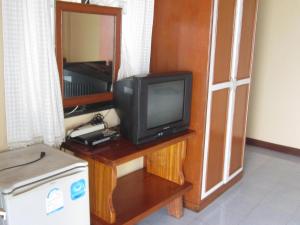 a small television sitting on a table in a room at Charung Beach in Haad Rin