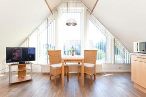 TV a/nebo společenská místnost v ubytování Ferienwohnungen Haus Sternenlicht