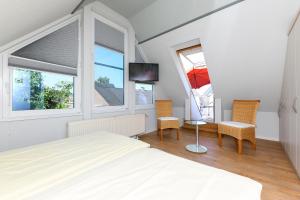 TV a/nebo společenská místnost v ubytování Ferienwohnungen Haus Sternenlicht