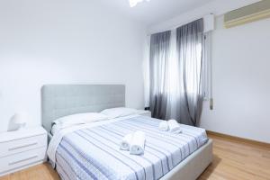 a bedroom with a bed with two towels on it at Cesare, Bologna by Short Holidays in Bologna