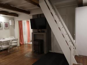 un salon avec une table et un escalier blanc dans l'établissement Lilla Huset, à Stöllet
